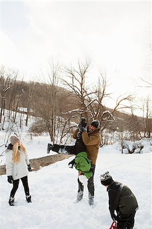 people playing in the snow - Family playing in snow Stock Photo - Premium Royalty-Free, Code: 6122-07696540