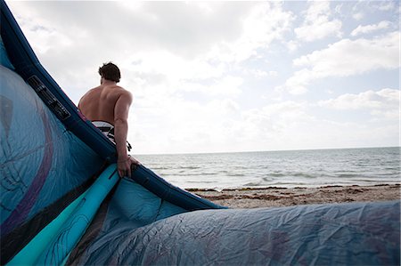 Kitesurfer on beach Stock Photo - Premium Royalty-Free, Code: 6122-07696682