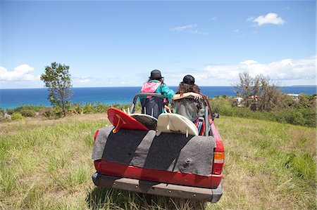 Off road vehicle driving toward beach with two women in back Stock Photo - Premium Royalty-Free, Code: 6122-07696947