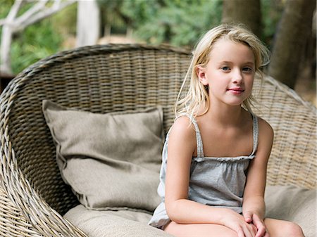 simsearch:6122-07698204,k - Girl sitting in wicker chair, portrait Stock Photo - Premium Royalty-Free, Code: 6122-07697000