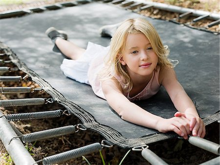 simsearch:6122-07698204,k - Girl lying on trampoline Stock Photo - Premium Royalty-Free, Code: 6122-07697013