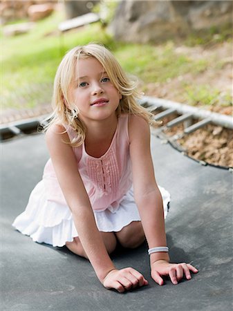simsearch:6122-07698204,k - Girl kneeling on trampoline Stock Photo - Premium Royalty-Free, Code: 6122-07697010