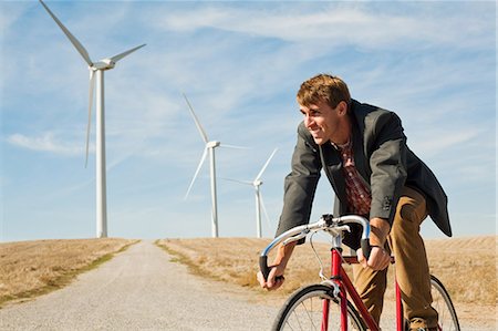 pedal - Man on bicycle in front of wind turbines Stock Photo - Premium Royalty-Free, Code: 6122-07697707