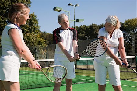 Senior and mature adults practising on tennis courts Stock Photo - Premium Royalty-Free, Code: 6122-07697841