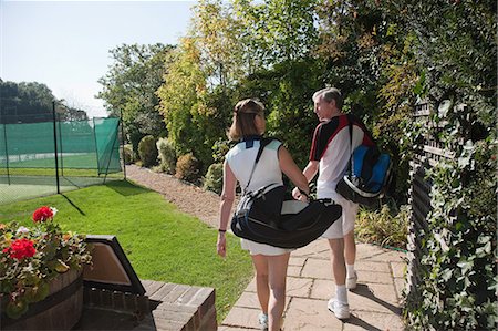 Couple walking to tennis courts Stock Photo - Premium Royalty-Free, Code: 6122-07697836