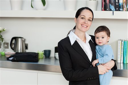 picture of a baby boy smiling - Businesswoman holding baby son Stock Photo - Premium Royalty-Free, Code: 6122-07698013