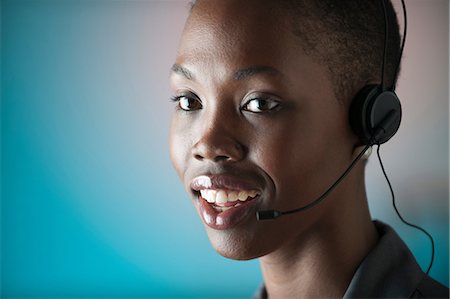 Young woman wearing telephone headset Stock Photo - Premium Royalty-Free, Code: 6122-07698177
