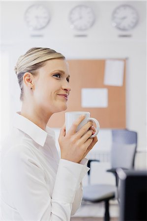 simsearch:614-06718128,k - Woman drinking coffee in office Stock Photo - Premium Royalty-Free, Code: 6122-07698209