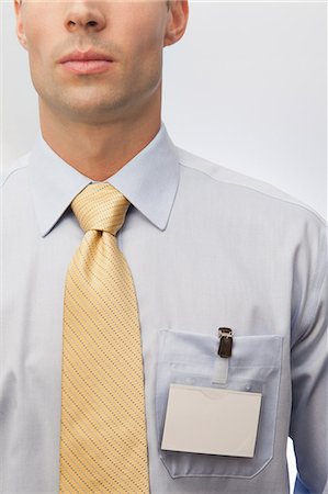 shirt tie - Young man wearing tie and name badge Stock Photo - Premium Royalty-Free, Code: 6122-07698214