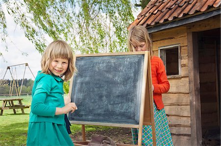 simsearch:6122-07698204,k - Two girls outdoors with blackboard Stock Photo - Premium Royalty-Free, Code: 6122-07698483