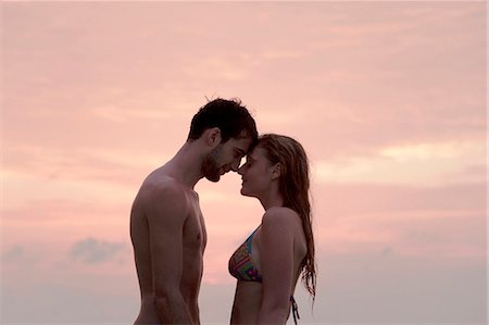 simsearch:6122-07699140,k - Couple hugging on beach at sunset Foto de stock - Sin royalties Premium, Código: 6122-07699033