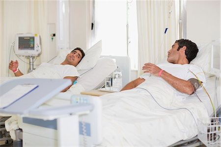 Patients talking in hospital beds Stock Photo - Premium Royalty-Free, Code: 6122-07699186