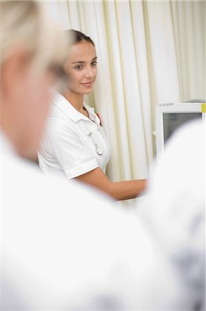 simsearch:6113-07905850,k - Nurse using equipment in hospital Stock Photo - Premium Royalty-Free, Code: 6122-07699194