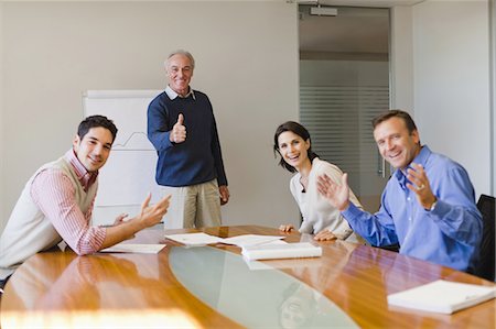 simsearch:649-06000952,k - Business people cheering in meeting Stock Photo - Premium Royalty-Free, Code: 6122-07699412
