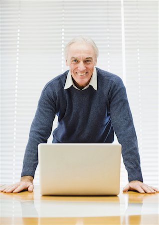 simsearch:6113-07565805,k - Businessman at laptop in office Stock Photo - Premium Royalty-Free, Code: 6122-07699414