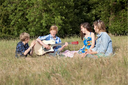simsearch:632-06029740,k - Children playing music together in field Stock Photo - Premium Royalty-Free, Code: 6122-07700193