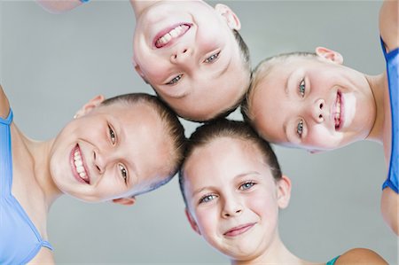 pre teens in leotards - Ballet dancers with heads together Stock Photo - Premium Royalty-Free, Code: 6122-07700333