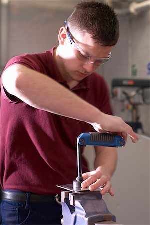 Worker using machinery in factory Stock Photo - Premium Royalty-Free, Code: 6122-07700644