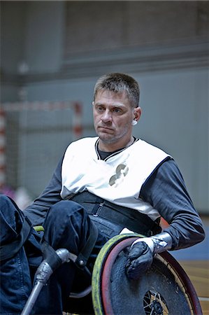 disable exercising - Man in wheelchair playing indoor sports Stock Photo - Premium Royalty-Free, Code: 6122-07701186