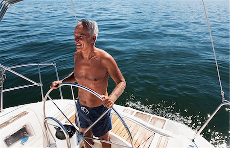 Older man sailing on lake Stock Photo - Premium Royalty-Free, Code: 6122-07701403