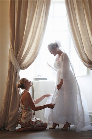 Woman helping bride get dressed Stock Photo - Premium Royalty-Free, Code: 6122-07702077