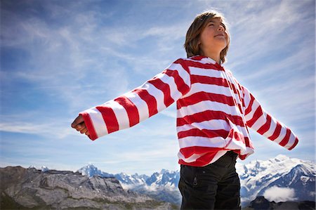 Boy standing in rocky landscape Stock Photo - Premium Royalty-Free, Code: 6122-07702039