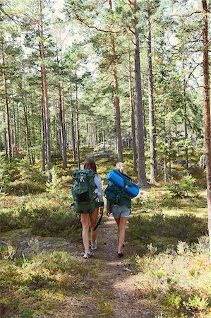 freedom backpacking - Women hiking in forest together Stock Photo - Premium Royalty-Free, Code: 6122-07702179