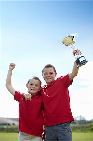 friends lifting someone - Boys cheering with trophy outdoors Photographie de stock - Premium Libres de Droits, Code: 6122-07702321