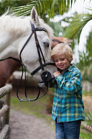 simsearch:649-05649029,k - Boy hugging horse in yard Stock Photo - Premium Royalty-Free, Code: 6122-07702646
