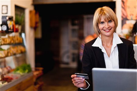 simsearch:400-04410667,k - Businesswoman shopping online in cafe Stock Photo - Premium Royalty-Free, Code: 6122-07702613