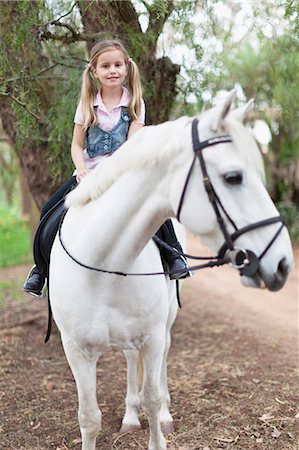 simsearch:649-05649029,k - Smiling girl riding horse in park Stock Photo - Premium Royalty-Free, Code: 6122-07702634