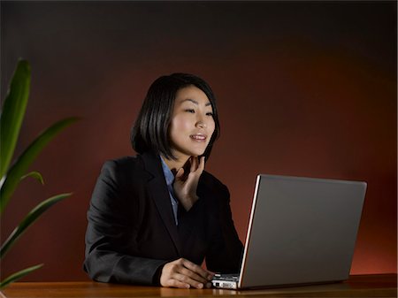 simsearch:614-02985267,k - Businesswoman using laptop at desk Stock Photo - Premium Royalty-Free, Code: 6122-07702990