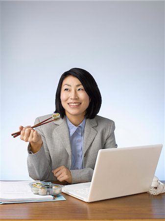 simsearch:614-02985267,k - Businesswoman eating and working at desk Stock Photo - Premium Royalty-Free, Code: 6122-07702994