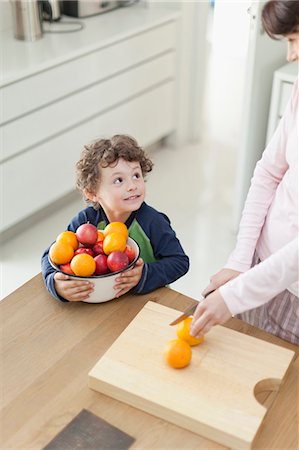 simsearch:649-05521576,k - Mother and son slicing fruit in kitchen Stock Photo - Premium Royalty-Free, Code: 6122-07703068