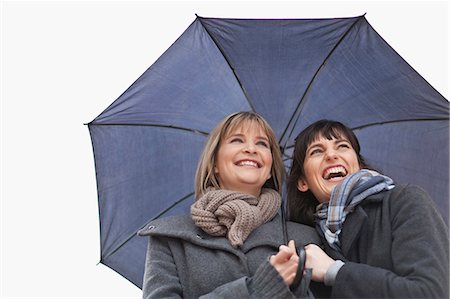 shielding - Smiling women under umbrella Stock Photo - Premium Royalty-Free, Code: 6122-07703183