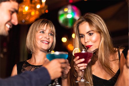 Smiling women having cocktails in club Stock Photo - Premium Royalty-Free, Code: 6122-07703123