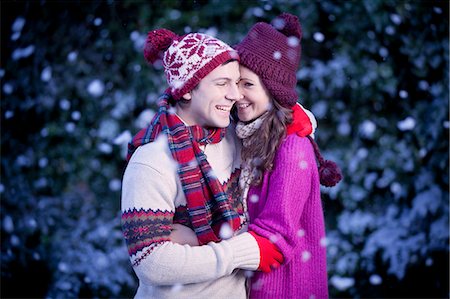 Smiling couple hugging in snow Stock Photo - Premium Royalty-Free, Code: 6122-07703276