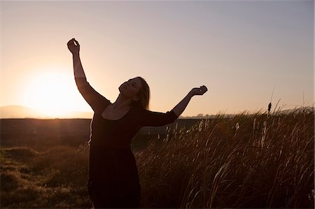 Woman standing in wheat field Stock Photo - Premium Royalty-Free, Code: 6122-07703418