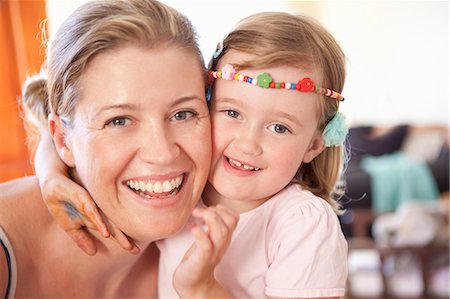simsearch:6108-05872072,k - Smiling mother and daughter hugging Stock Photo - Premium Royalty-Free, Code: 6122-07703436
