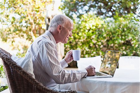 simsearch:6113-07730780,k - Older man using laptop outdoors Stock Photo - Premium Royalty-Free, Code: 6122-07703538