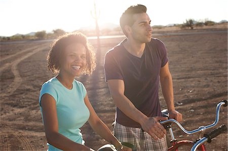 simsearch:6113-07147024,k - Couple with bicycles in desert landscape Stock Photo - Premium Royalty-Free, Code: 6122-07704084