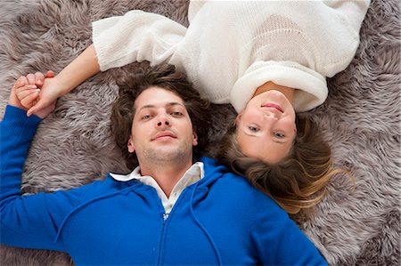 simsearch:649-05556309,k - Couple relaxing together on rug Stock Photo - Premium Royalty-Free, Code: 6122-07704287