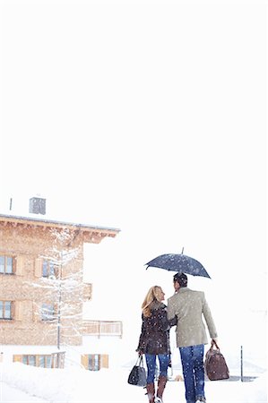 simsearch:6122-07704462,k - Couple walking together in snow Stock Photo - Premium Royalty-Free, Code: 6122-07704488