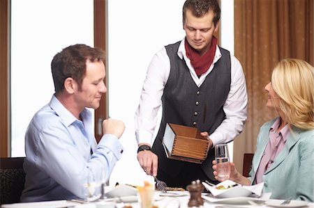 simsearch:6122-07704462,k - Waiter serving business people in cafe Stock Photo - Premium Royalty-Free, Code: 6122-07704428