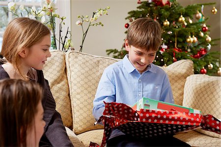 Children opening Christmas gifts Stock Photo - Premium Royalty-Free, Code: 6122-07704859