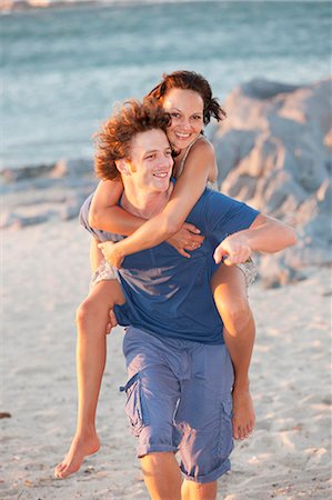 Man carrying girlfriend piggyback Stock Photo - Premium Royalty-Free, Code: 6122-07704916