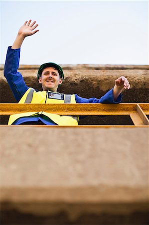 simsearch:649-06532718,k - Worker waving from balcony Stock Photo - Premium Royalty-Free, Code: 6122-07705079