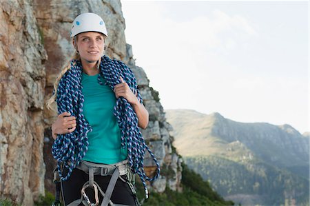 simsearch:649-05949892,k - Climber holding coiled rope on mountain Photographie de stock - Premium Libres de Droits, Code: 6122-07705002
