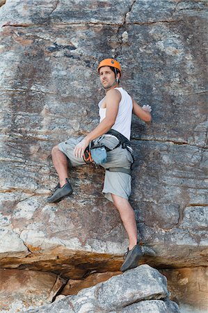 simsearch:649-05949892,k - Climber scaling steep rock face Photographie de stock - Premium Libres de Droits, Code: 6122-07705008