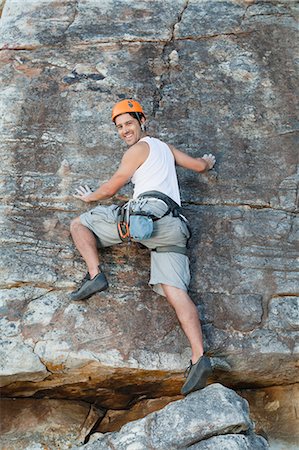 Climber scaling steep rock face Stock Photo - Premium Royalty-Free, Code: 6122-07705009